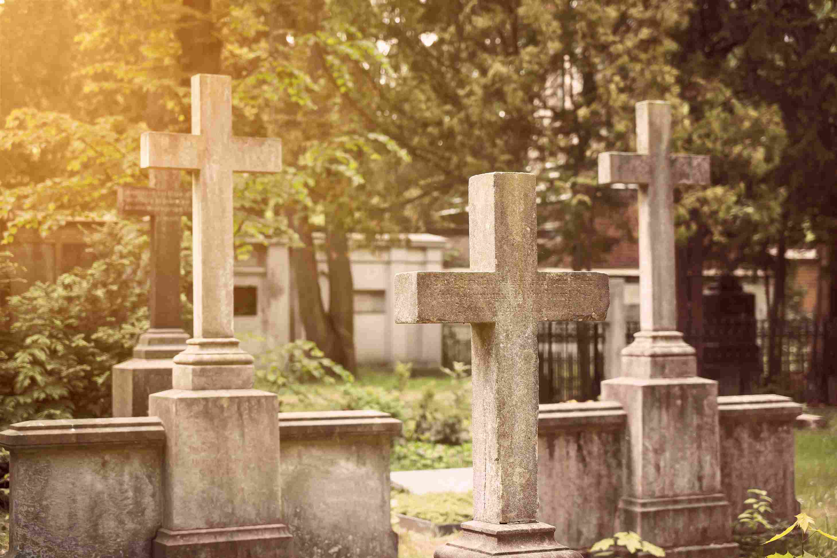 Gravestones with crosses in a cemetery.
